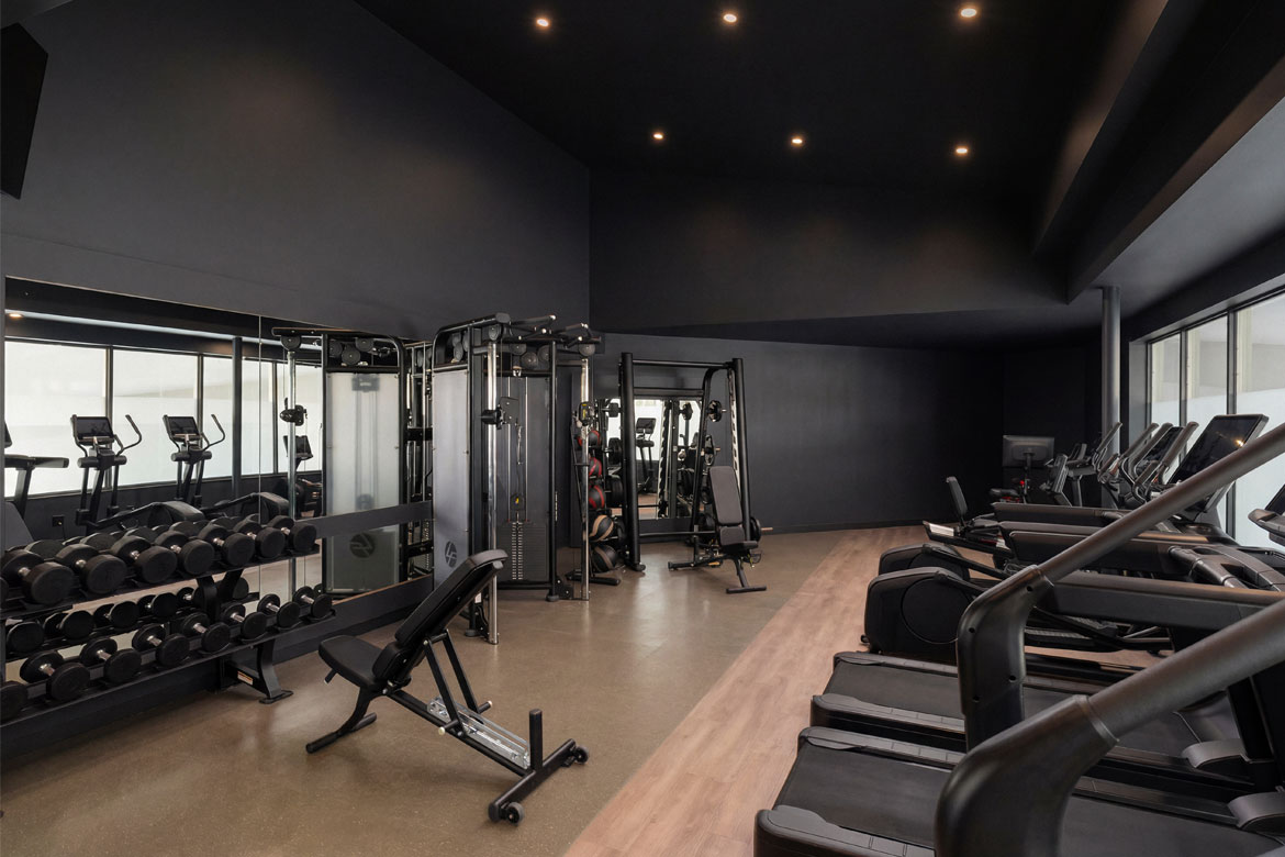 Modern gym with multiple treadmills and a variety of exercise equipment for effective workouts.
